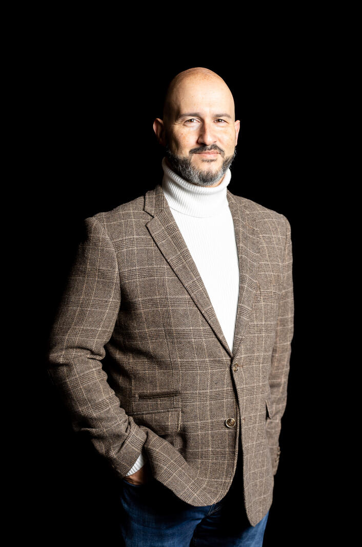 man in suit jacket with black background