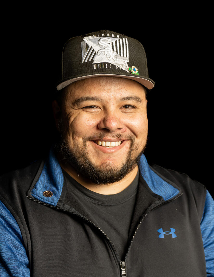 portrait of man with hat and black background